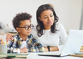 woman and child with glasses looking at the computer laptop