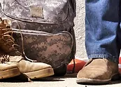 a close-up of a backpack and a man's shoes
